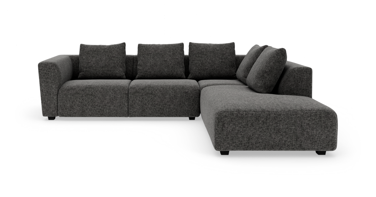 Mørkegrå L‑sofa med chaiselong til højre, frilagt på hvid baggrund.