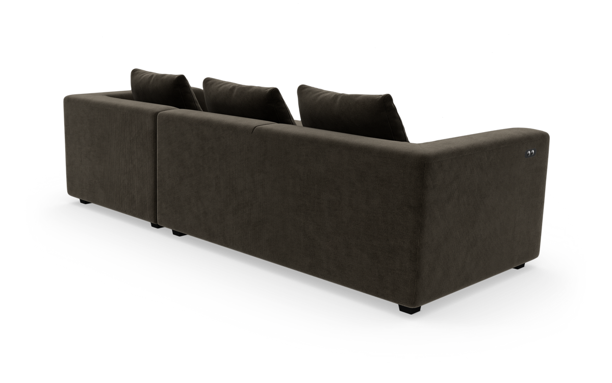Mørkebrun modulsofa set bagfra i studiemiljø.