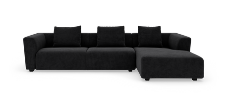 Sort modulsofa med chaiselong til højre og fire ryghynder, fritlagt på hvid baggrund.