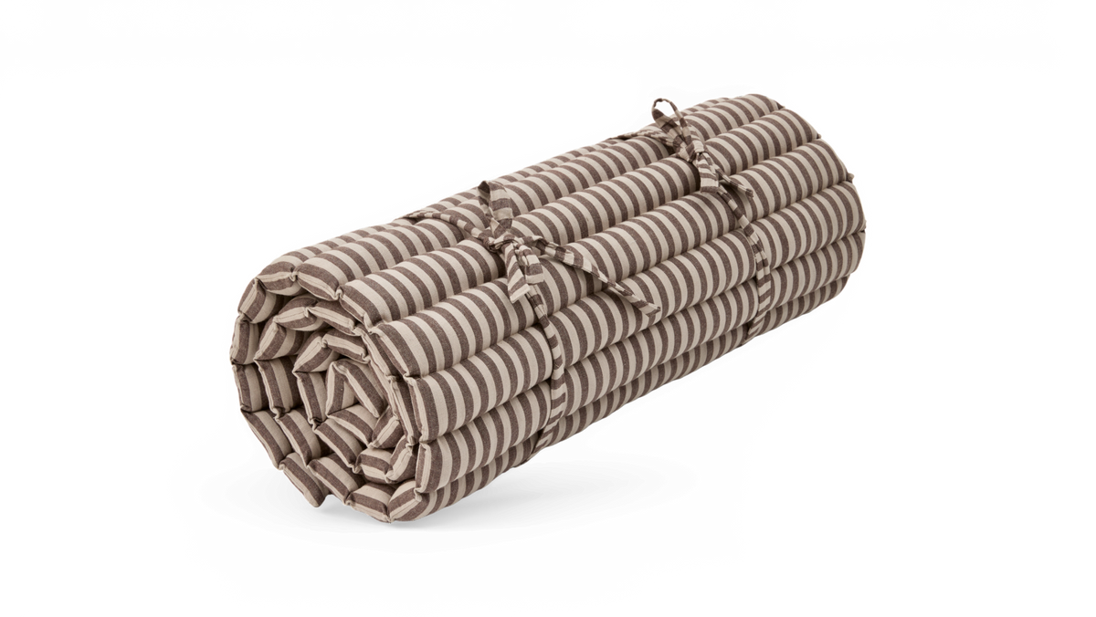 Sammenrullet stribet sædehynde/madras i beige og hvid med bindebånd.