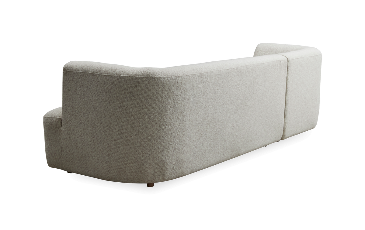 Bagvendt beige modulsofa med afrundede former på hvid frilægning.
