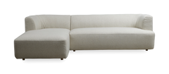 L‑formet lys beige hjørnesofa med venstrevendt chaiselong, bløde afrundede former i boucléstof, frilagt på mørk baggrund.