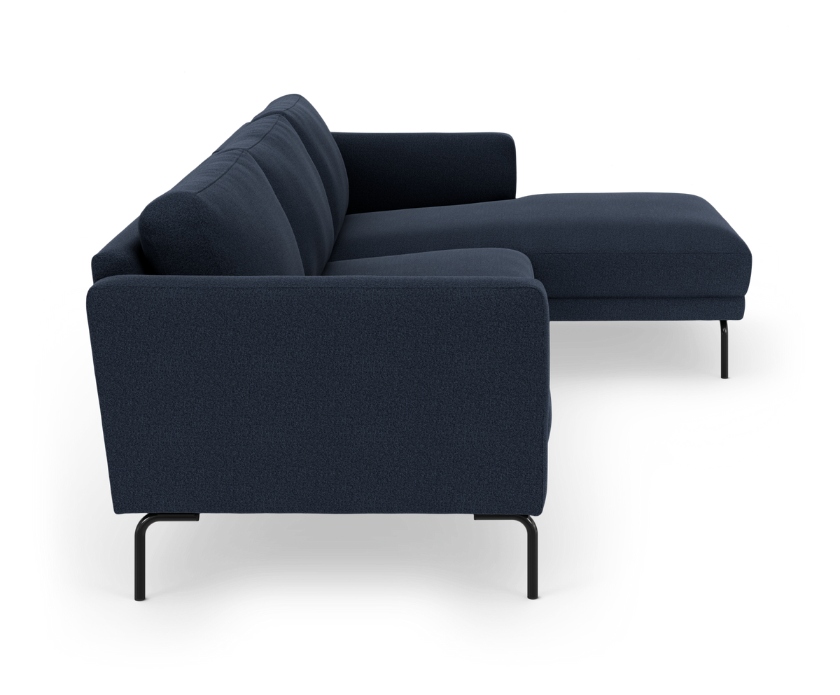 Mørkeblå modulsofa med chaiselong til højre på sorte metalben, fritlagt mod hvid baggrund.
