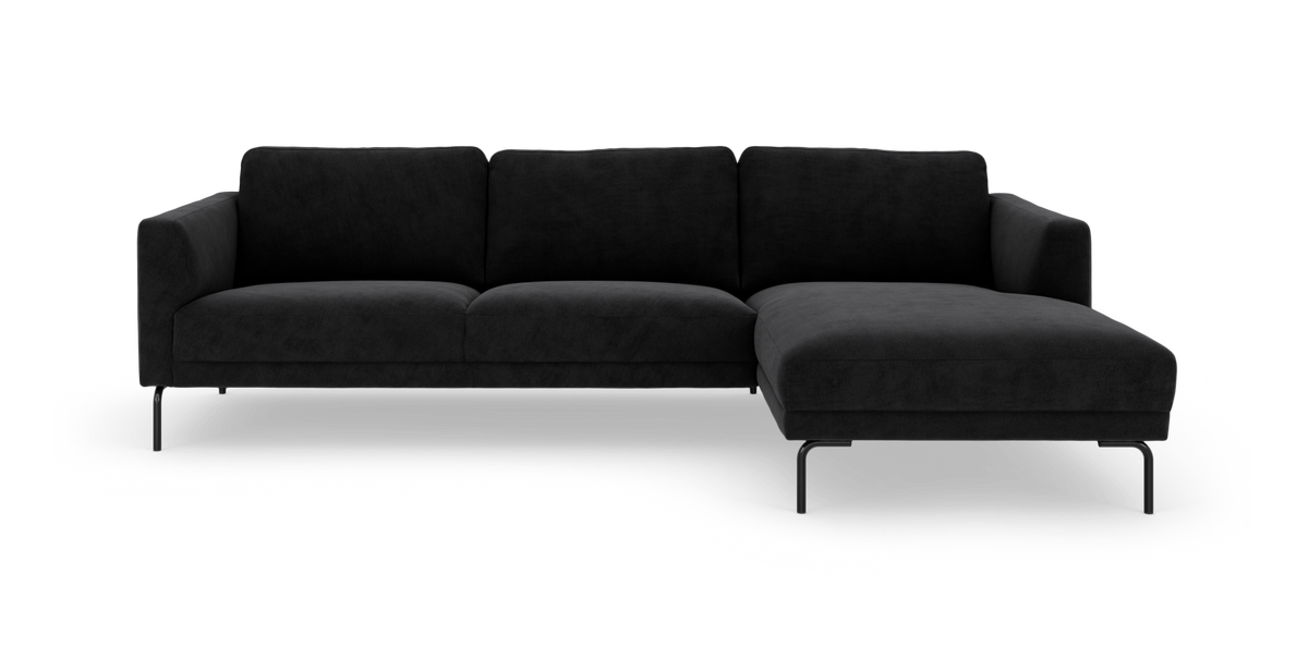Sort hjørnesofa med chaiselong til højre på hvid baggrund.