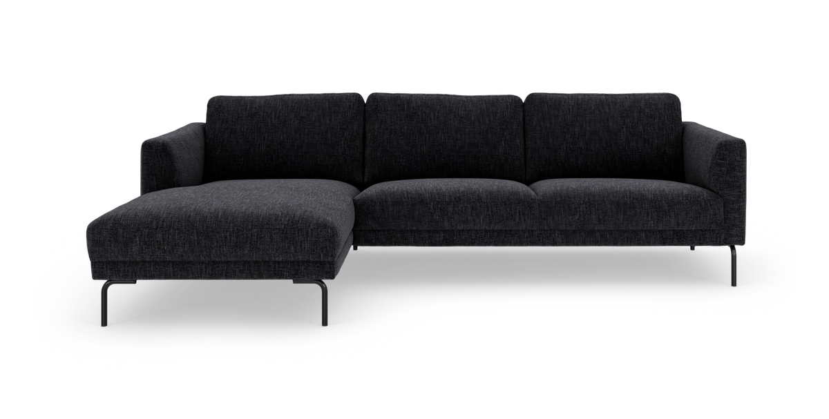 Mørkegrå hjørnesofa med venstrevendt chaiselong på slanke metalben, frilagt på hvid baggrund.
