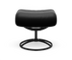 Sort læderfodskammel med rund metalbase, frontvisning på hvid baggrund.
