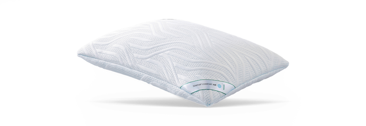 Hvid Tempur Comfort Air-pude i medium med bølgemønstret, struktureret overflade frilagt på hvid baggrund.