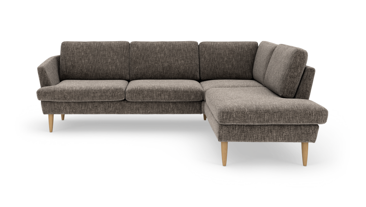 Mørkegrå hjørnesofa med chaiselong til højre og lyse træben.