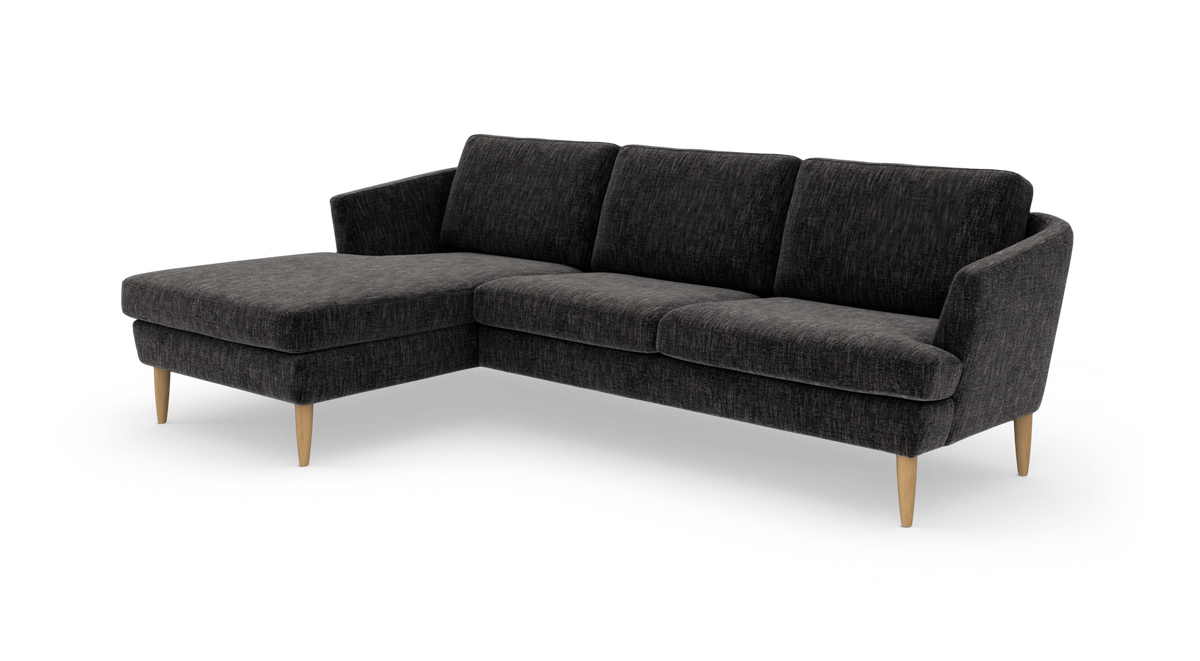 Mørkegrå hjørnesofa med venstrevendt chaiselong og slanke træben i moderne skandinavisk design.