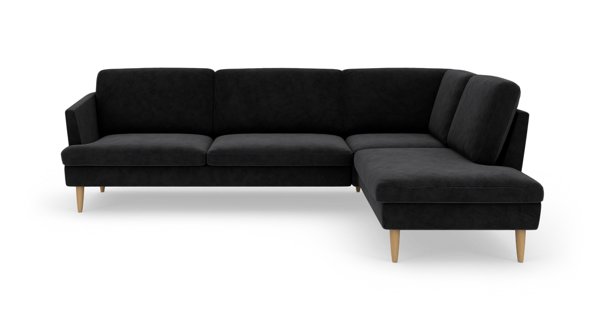 Sort L‑sofa med højrevendt chaiselong og lyse træben, frilagt på hvid baggrund.
