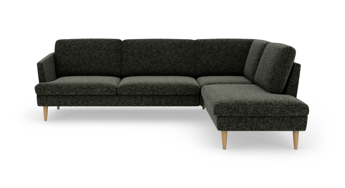 Mørkegrå L-formet hjørnesofa med træben, frilagt.