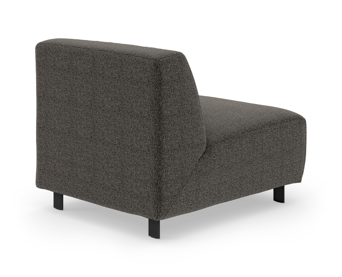 Mørkegrå modulsofa uden armlæn med slanke sorte ben, set skråt bagfra på hvid baggrund.