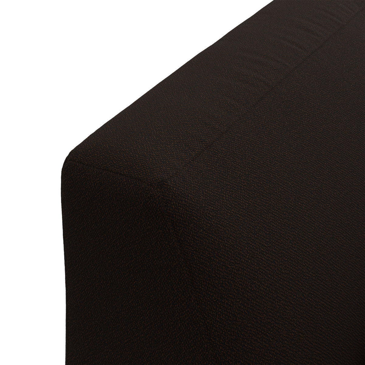 Nærbillede af mørkebrun, tekstureret stofbetrukket møbelhjørne (sofa/ottoman), frilagt mod mørk baggrund.