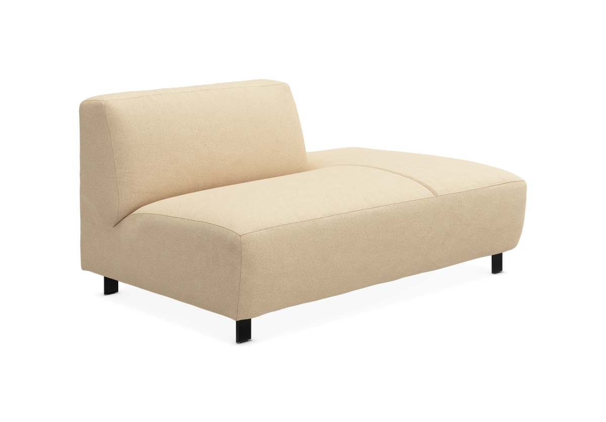 Beige modulsofa med lav ryg og chaiselong-del, fritstående på hvid baggrund.