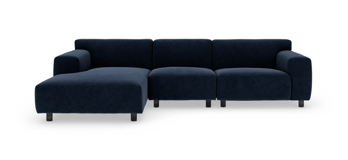 Mørkeblå modulsofa med chaiselong, frilagt på hvid baggrund.