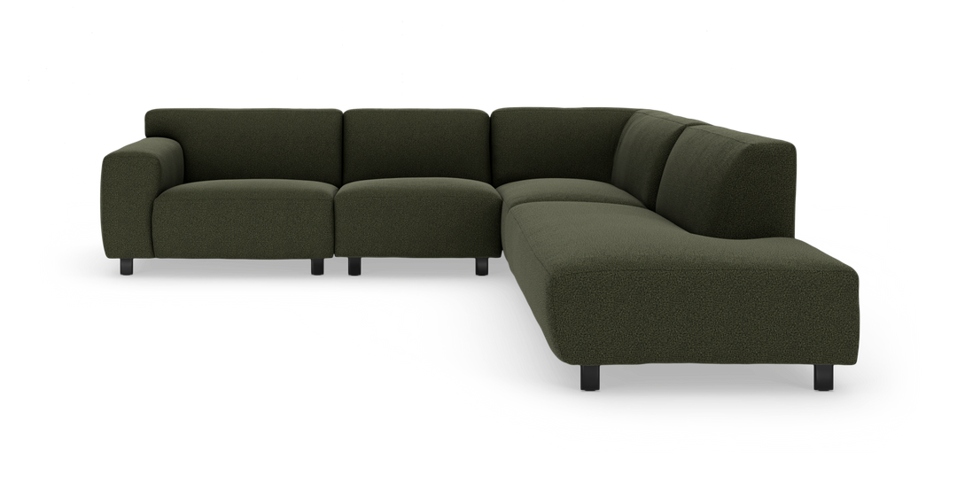Mørkegrøn modulær hjørnesofa med afrundede former og sorte ben.