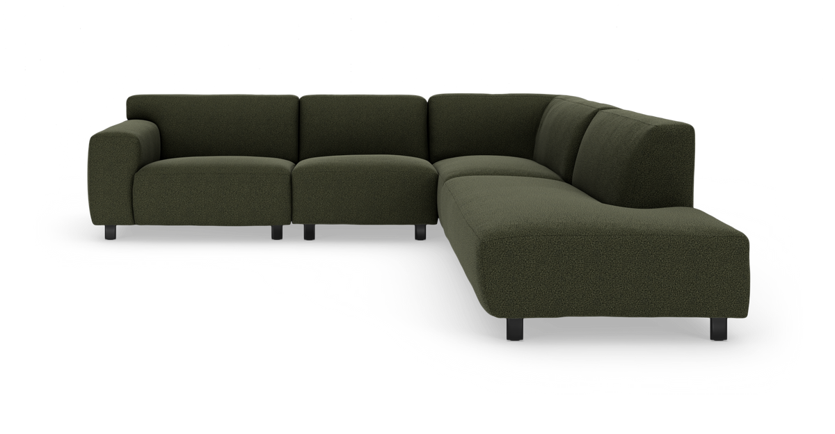Mørkegrøn modulær hjørnesofa med afrundede former og sorte ben.