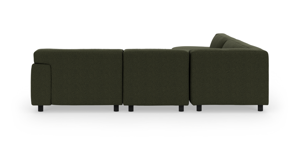 Mørkegrøn modulsofa set bagfra på hvid baggrund.