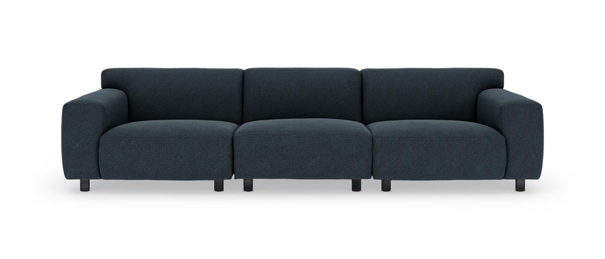 Mørkeblå modulsofa med afrundede armlæn, set forfra mod hvid baggrund.