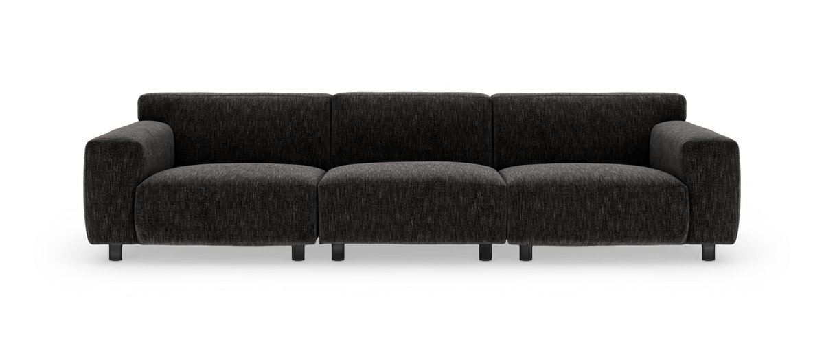 Mørkegrå modulsofa med brede armlæn, set forfra på hvid baggrund.