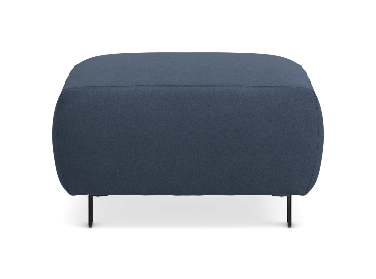 Rektangulær blå polstret puf med afrundede kanter og slanke sorte ben, frontvisning på hvid baggrund.