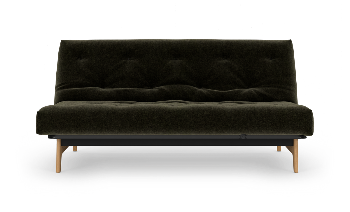 Mørkegrøn tufted sovesofa med træben, fritlagt forfra.