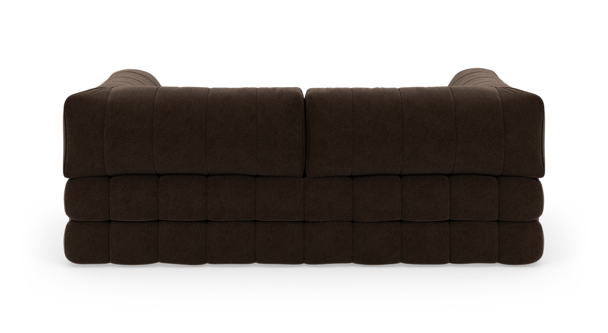 Modulsofa i mørkebrunt stof set bagfra, centreret mod hvid studiebaggrund.