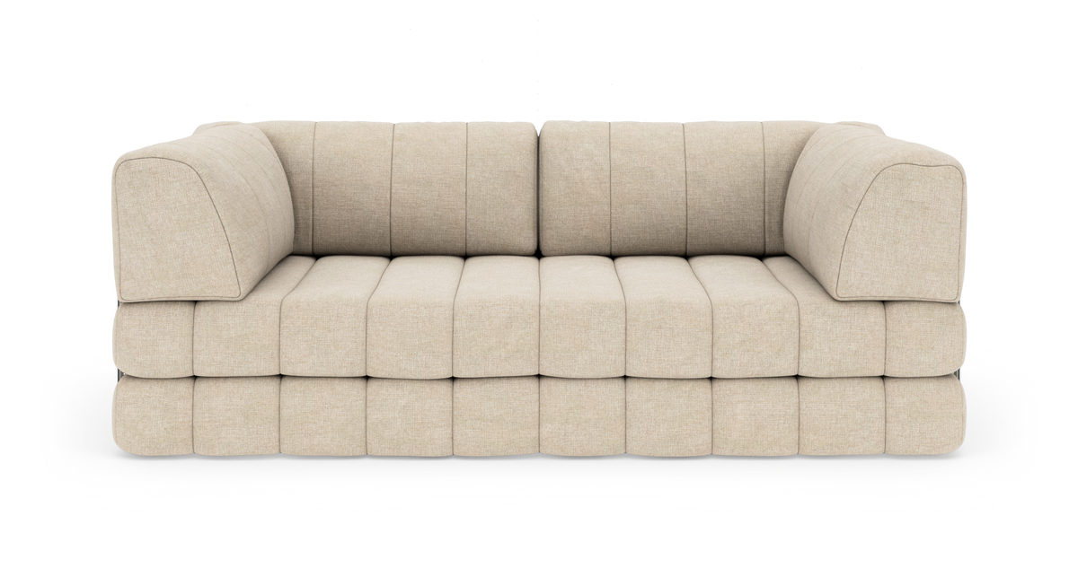 Beige modulsofa med afrundede blokpuder, frontvisning, fritlagt på hvid baggrund.