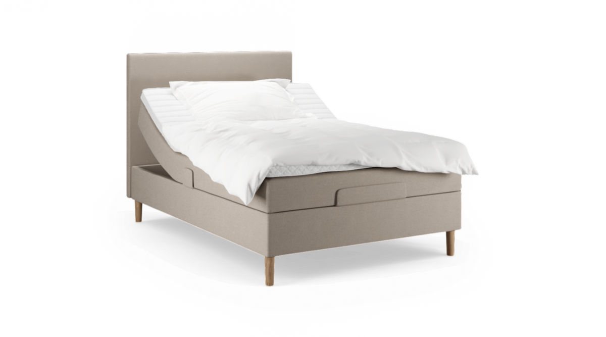 Beige elevationsseng med sengegavl, hvidt sengetøj og træben, rygdelen hævet.