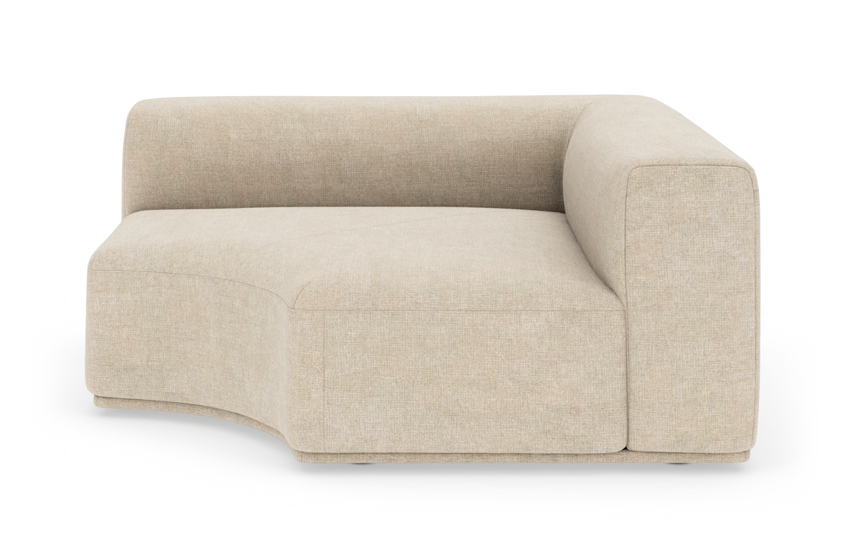 Beige modulsofa med afrundet hjørne i studiemiljø, set i frontvinkel.
