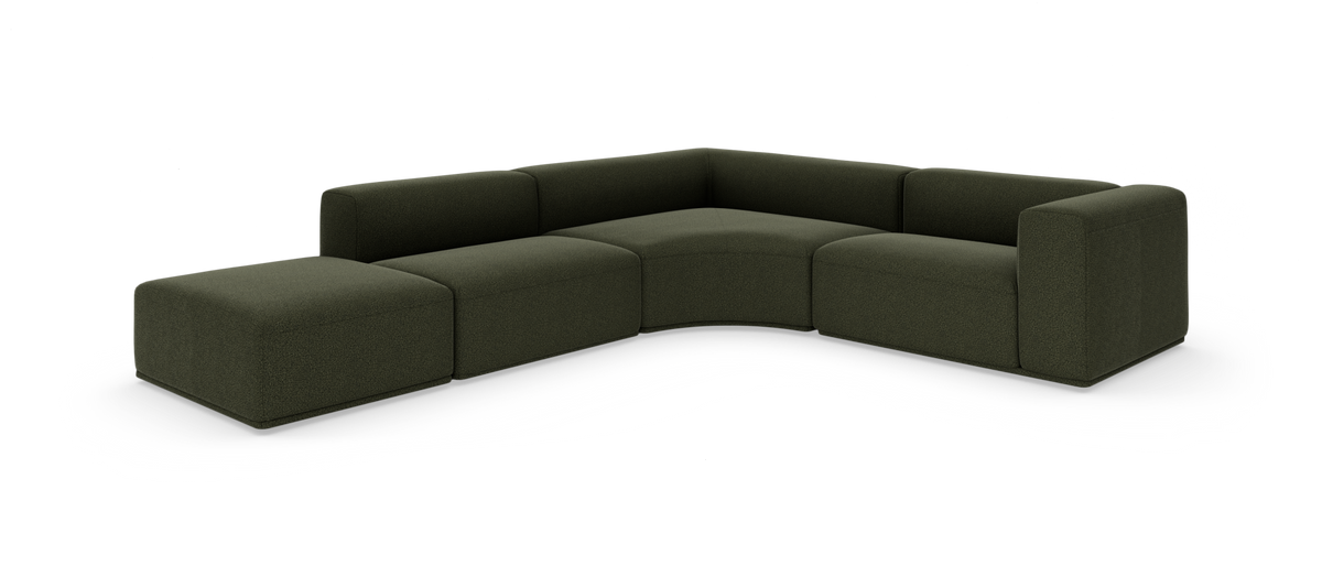 Modulær L‑sofa i mørkegrønt stof med afrundet inderhjørne, vist på hvid baggrund.
