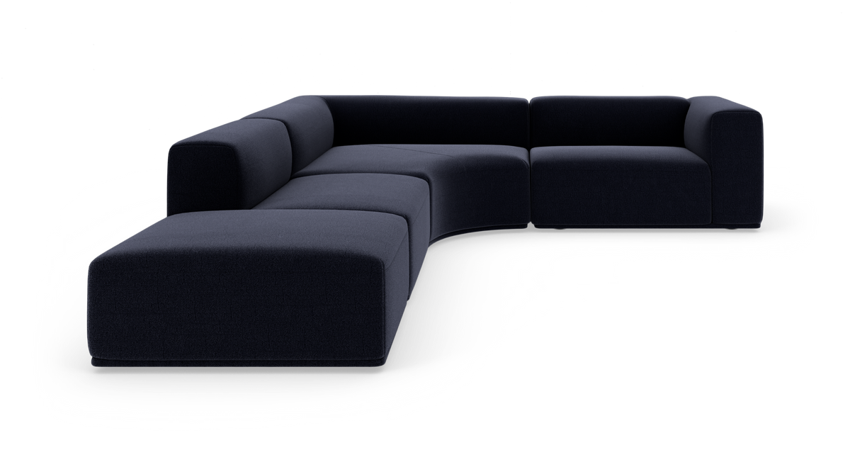 Modulær mørkeblå hjørnesofa med afrundede former i L‑layout på hvid baggrund.