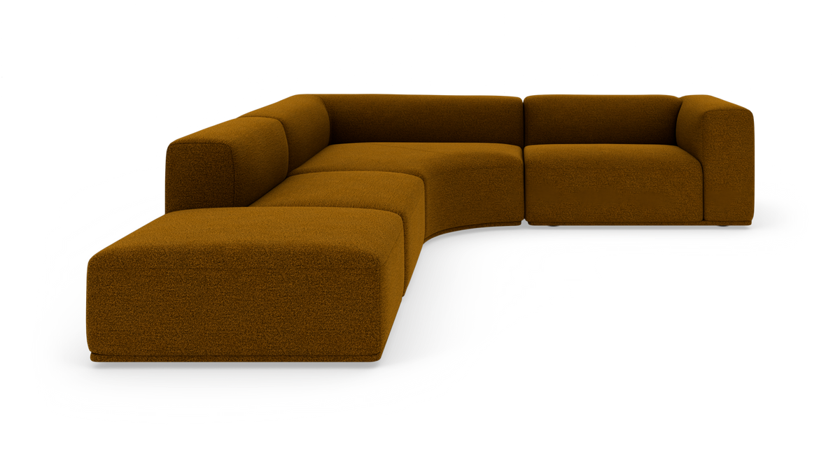 Modulær L‑sofa i sennepsgul/brun tekstil med afrundede moduler, fritstående på hvid baggrund.