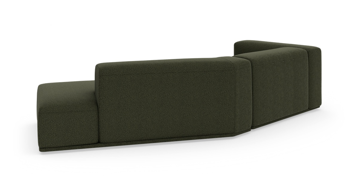 Mørkegrøn modulsofa set bagfra på hvid baggrund.