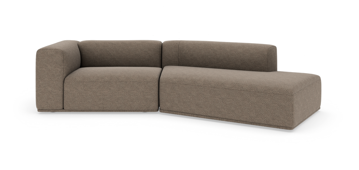 Modulsofa i taupe med højrevendt chaiselong og afrundede, bløde former på hvid baggrund.