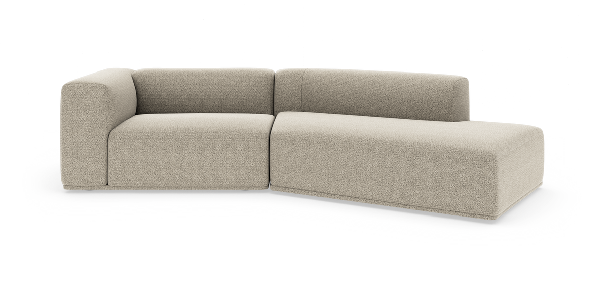 Beige modulsofa med chaiselong, moderne afrundet design på hvid baggrund.