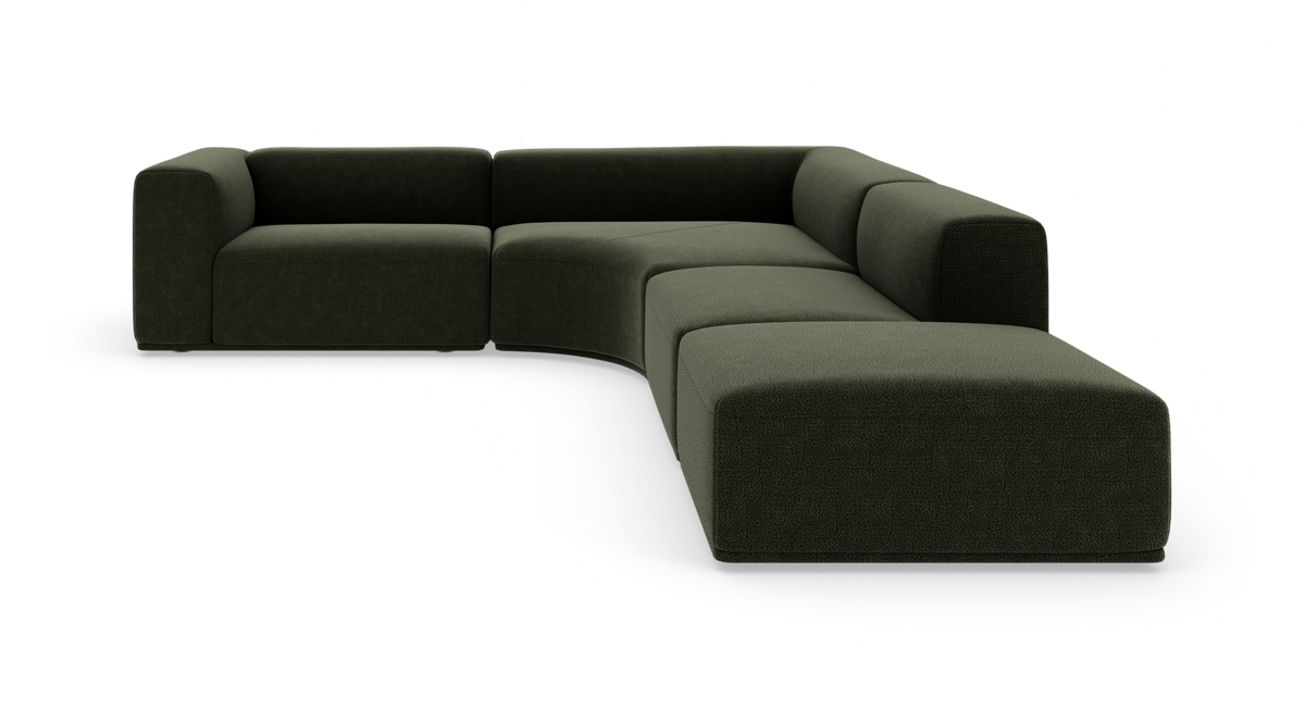 Modulsofa i mørkegrønt stof med afrundet hjørnesektion, fotograferet mod hvid baggrund.