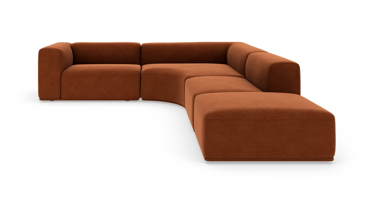Modulopbygget L-sofa i rustfarvet stof med bløde, afrundede former på hvid frilægning.