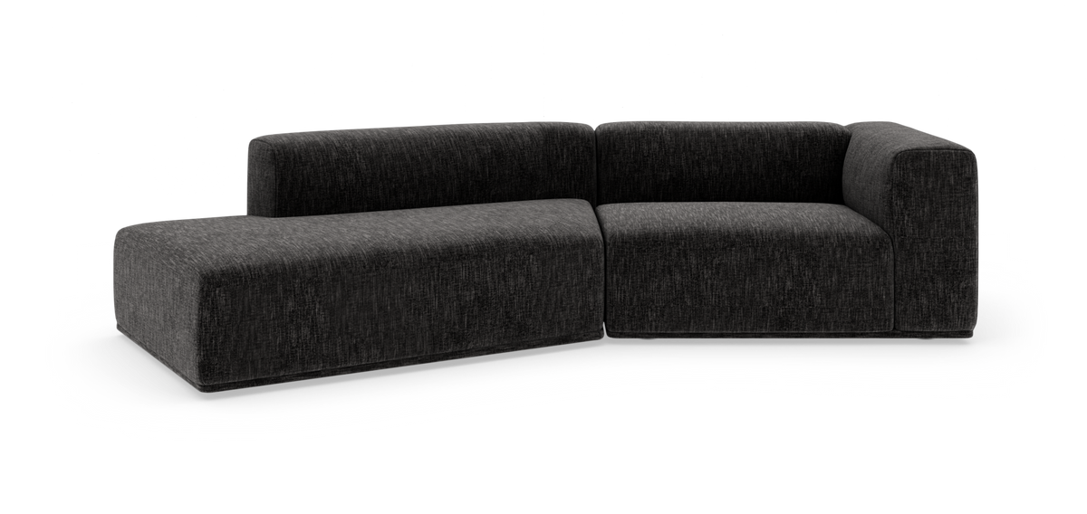 Mørkegrå L-formet modulsofa på hvid baggrund.