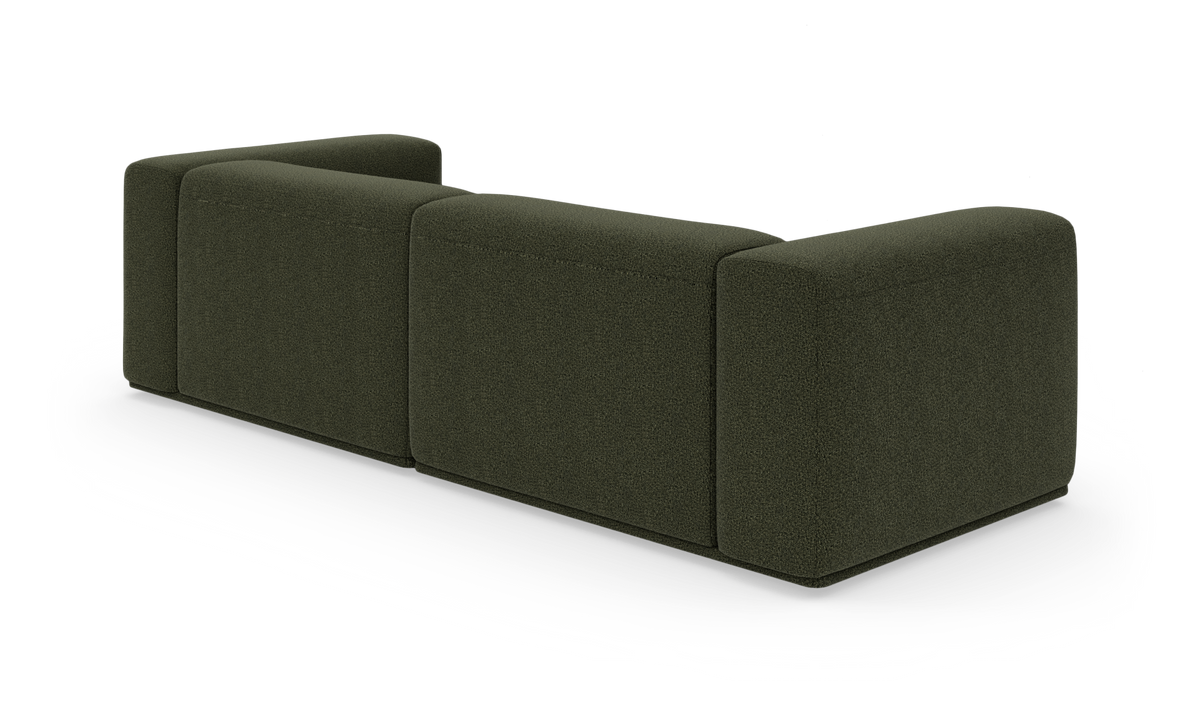 Mørkegrøn modulsofa set bagfra på hvid baggrund.