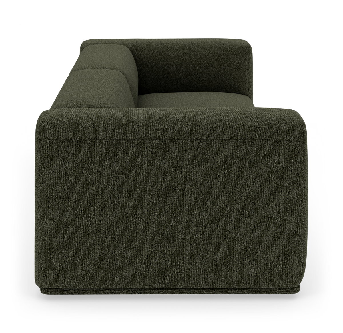 Mørkegrøn, moderne modulsofa set fra siden i studiemiljø.