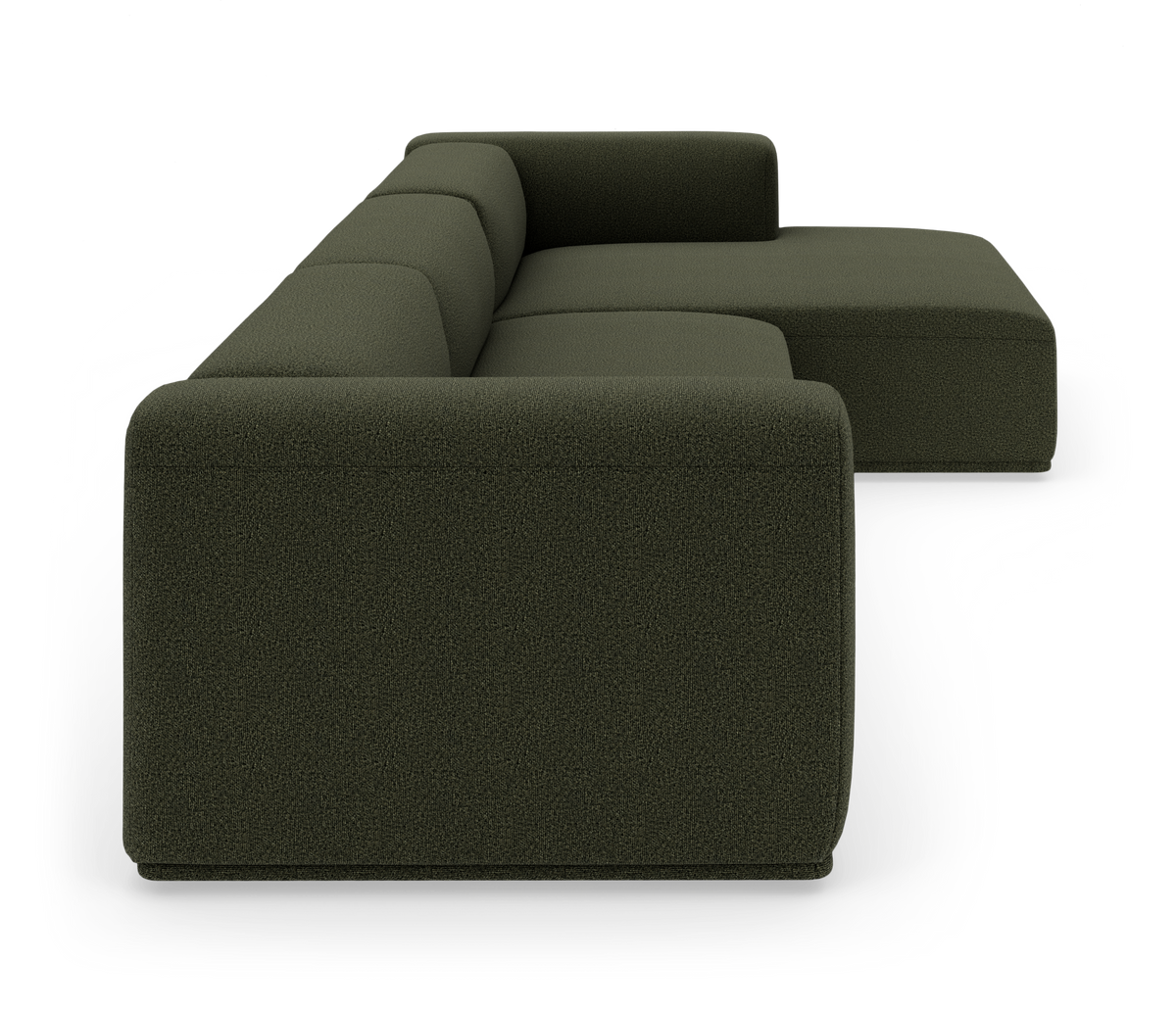 Mørkegrøn modulsofa med chaiselong, set fra siden i studiemiljø.
