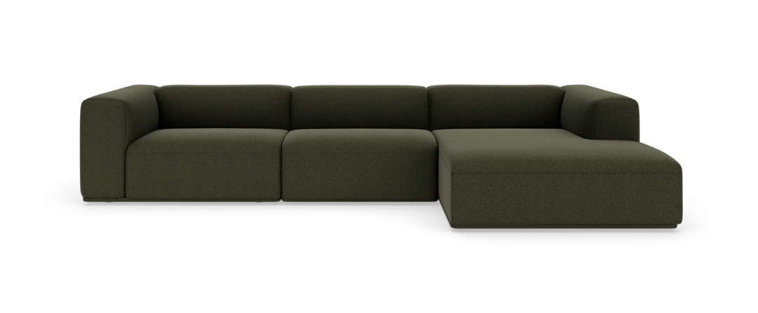 Mørkegrøn modulsofa med chaiselong i højre side, frilagt på hvid baggrund.