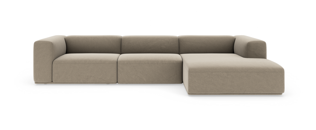 Beige modulsofa med chaiselong til højre, med bløde afrundede armlæn i moderne, minimalistisk design.