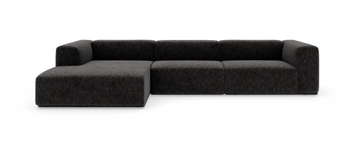 Mørkegrå modulsofa med venstrevendt chaiselong, fotograferet forfra mod hvid baggrund.