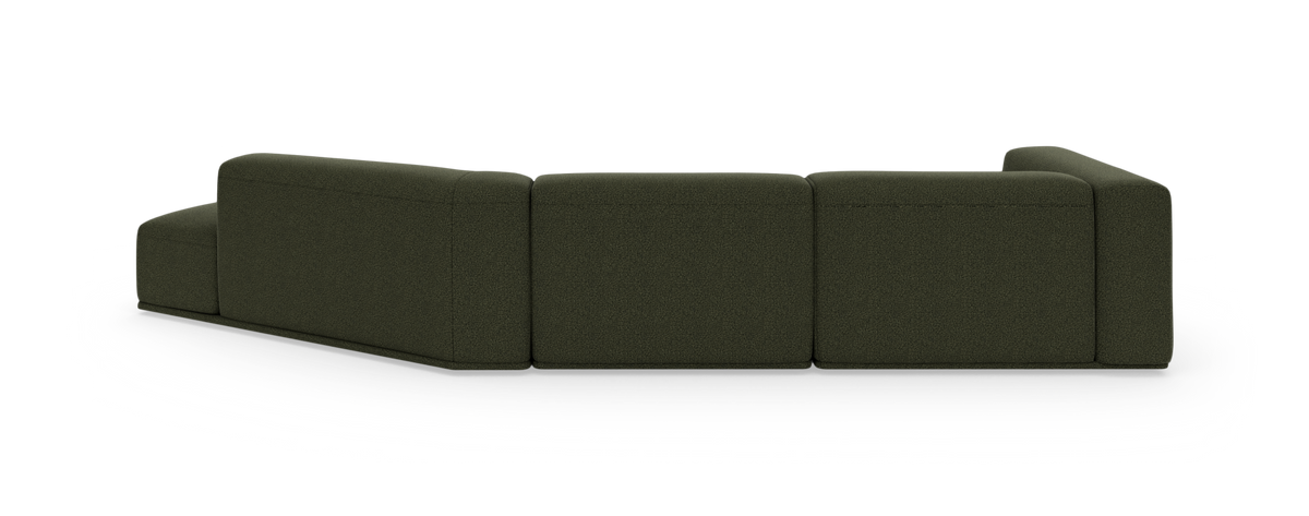 Mørkegrøn modulsofa set fra rygsiden på hvid studiebaggrund.