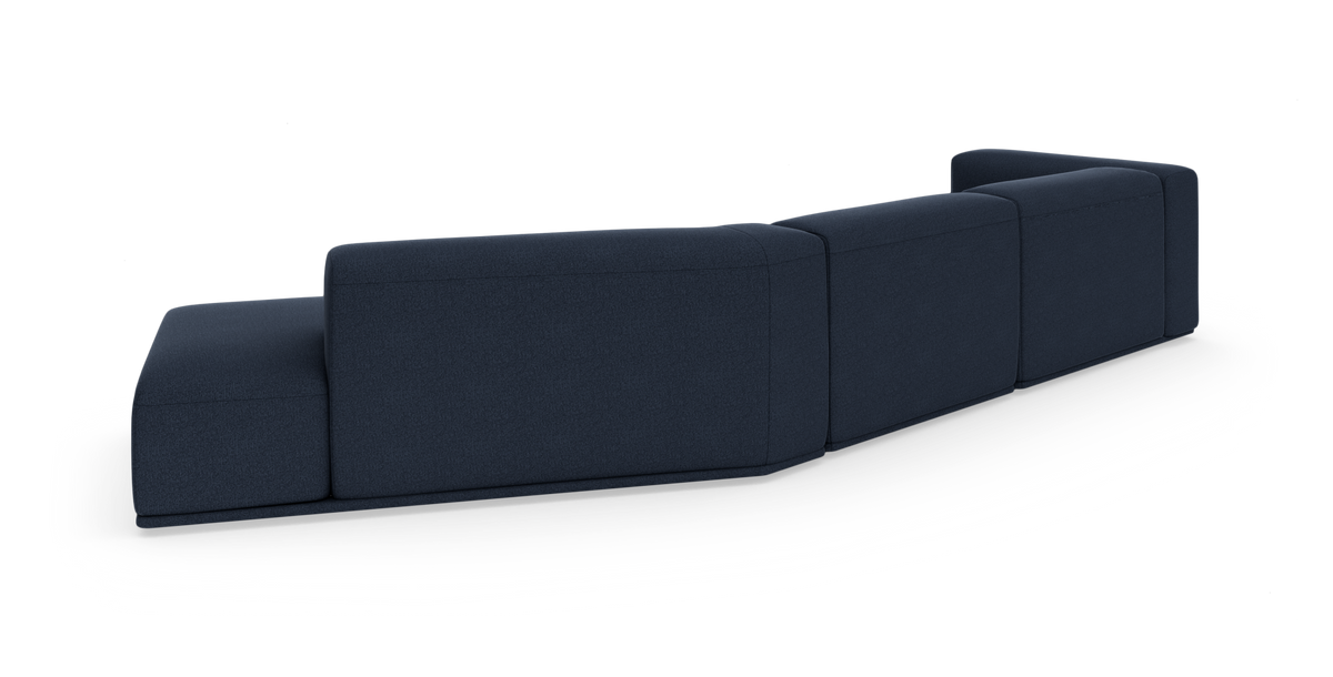 Modulsofa i mørkeblåt stof set bagfra, fritstående på hvid studiobaggrund.
