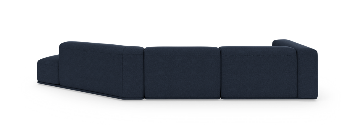 Mørkeblå modulsofa set bagfra i studiemiljø.