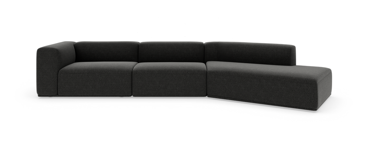 Mørkegrå modulsofa med højre chaiselong, lav profil og bløde, afrundede kanter på hvid baggrund.