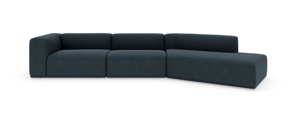 Modulsofa i mørkeblåt stof med højre chaiselong, fritlagt på hvid baggrund.